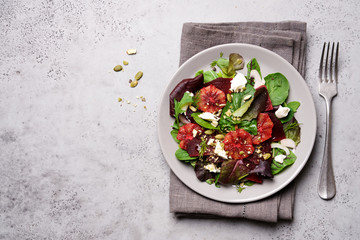 Beetroot salad with orange, cheese and mix of nuts, pumpkin seeds. Bright salad for cleen eating, detox
