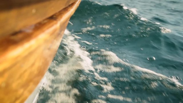 Wooden bow hull of a small traditional boat navigating