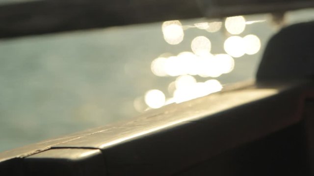 detail of a wooden boat rowing at golden sunset