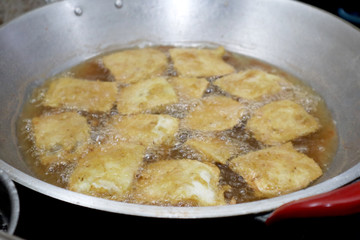 Cooking deep fried tempeh, Indonesian traditional meal, tempe goreng or gorengan