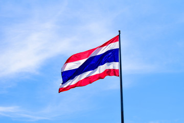 Thailand national flag waving in the wind against to blue sky
