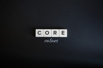 Core values concept. Block letters and cursive typography on black background.