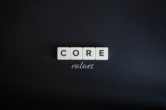 Core values concept. Block letters and cursive typography on black background.