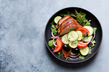 Roasted turkey or chicken breast with vegetables. Cucumbers, tomatoes, onions, olives and spices. Healthy salad for dinner