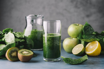 Green smoothie in  glass. Spinach, apple, kiwi, lemon, lime ingredients. Detox breakfast