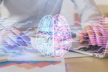 Businessman with computer background with brain theme hologram. Concept of brainstorm. Multi exposure.