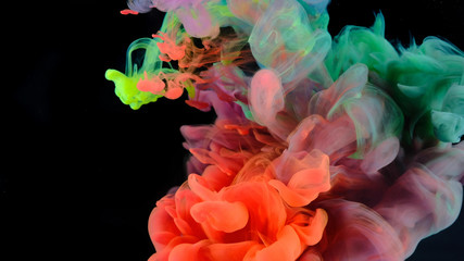 Obraz premium Color paint drops in water , abstract color mix , drop of Ink color mix paint falling on water Colorful ink in water, 