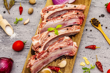 Raw pork ribs on grey stone concrete background