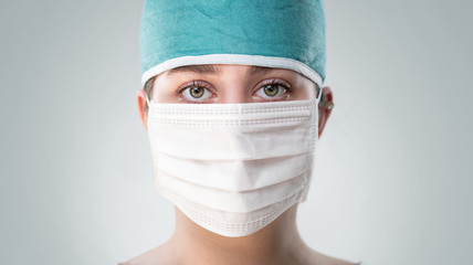 Close up of female doctor wearing face mask with copy space