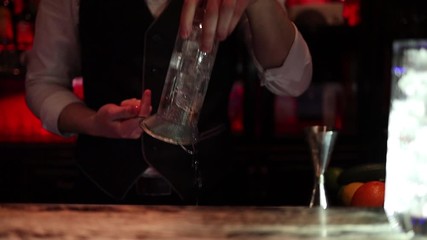 Bartender show. Elegant bartender makes cocktail in expensive restaurant. Drinking alcohol in nightclub or bar.