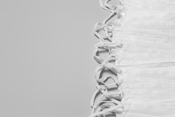 White medical mask on a gray background. Disposable medical masks. Face masks protecting against viruses. Health protection concept