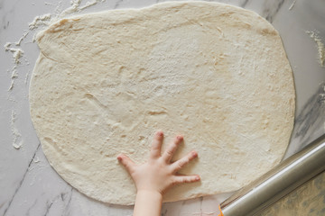 dough and kid's hand
