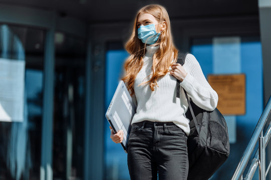 Beautiful Young Girl In A Mask From Coronovirus, Student On The Background Of Educational Envy, Women Returning From Work