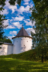 Fototapeta na wymiar Towers and fortress walls of the monastery. Svyato-Uspenskiy Pskovo-Pechersk monastery near Pskov, “God zdania cave.”