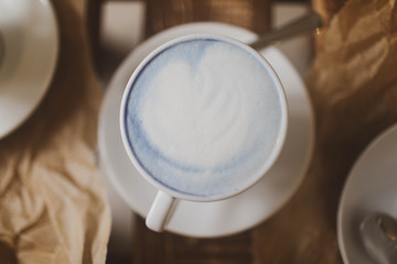 Obraz na płótnie Canvas blue tea matcha in a white mug on the table.