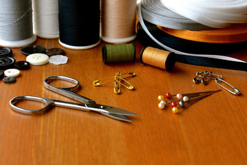Silver sewing scissors and sewing materials.
