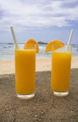 orange juice in transparent glasses and a milkshake