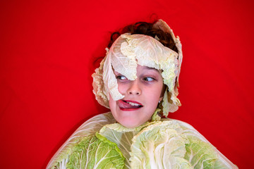 Young girl in a cabbage suit. Baby cabbage. Emotions, look, smile