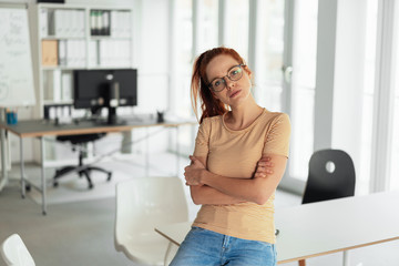 Thoughtful woman giving camera an assessing look