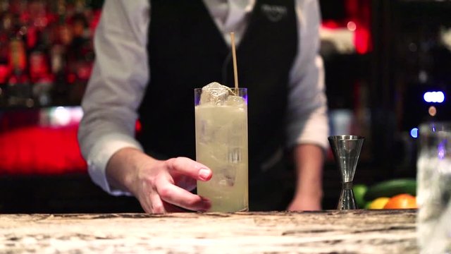Bartender show. Elegant bartender makes cocktail in expensive restaurant. Drinking alcohol in nightclub or bar.