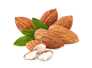 Almonds with leaves in closeup isolated on white background.