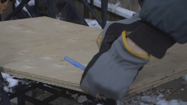 A Person Wearing Industrial Gloves Taking The Measurement Of A  Hardwood. -medium shot