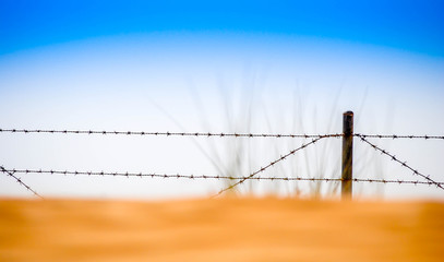 barbed iron fence with blue sky, dubai UAE