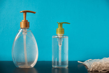 Antiseptic to treat hands from virus and bacteria on blue background