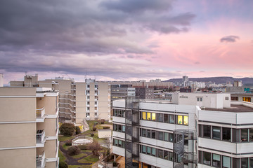 Beautiful sunset view of modern buildings and offices in Clermont Ferrand, France and colorful, purple sky