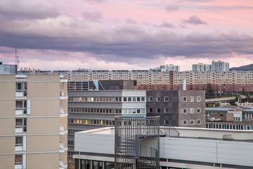 Fototapeta na wymiar Beautiful sunset view of modern buildings and offices in Clermont Ferrand, France and colorful, purple sky