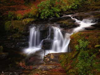 Fototapeta na wymiar Long exposure shot of Torc creek with small waterfall in Kerry mountains, Ireland