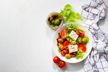 Healthy Greek salad on white surface top view