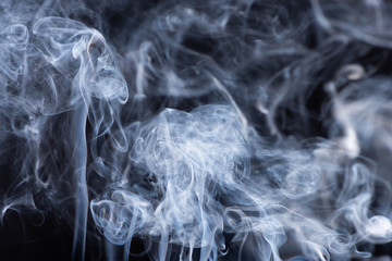 white flowing smoke clouds on black background