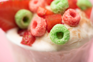 Selective focus of strawberry milkshake with ice cream and colorful candies
