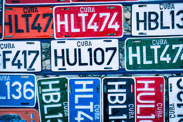 Traditional handcrafted vehicle registration plates like souvenirs for sale in Trinidad, Cuba.