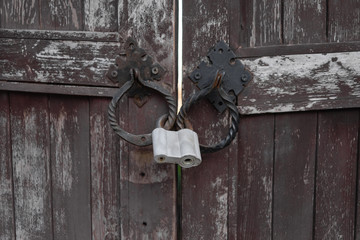 Closed metal lock door security protection padlock. old wooden door.