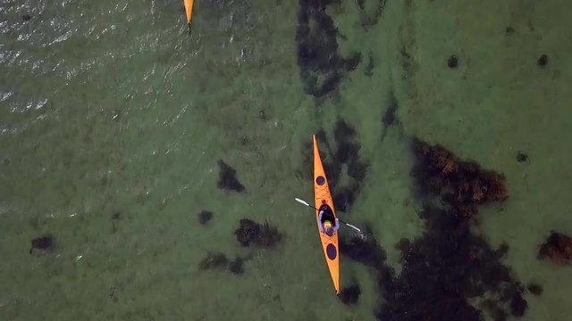 Aerial drone top down fly over kayakers. Northern Norway at beautiful Helgeland