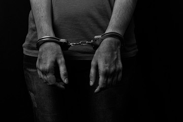 men and women cuffed hands together