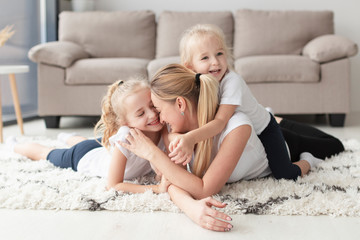 Happy mother and daughters posing at home