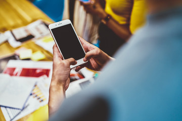 Cropped image of man's hands typing text messaging mobile phone chatting in social networks via 4G connection, selective focus on smartphone in use for sending multimedia and media content