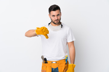 Craftsmen or electrician man over isolated white background showing thumb down sign