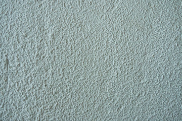The texture of the plastered white wall with a deep homogeneous structure.