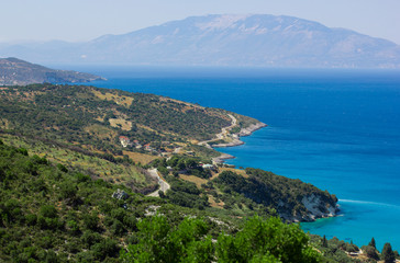 View on island shore surrounded by blue sea. Landscape from above
