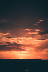 Beautiful sunset sky above clouds with dramatic light. 