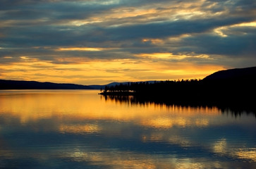 Fototapeta premium Orange sunset sky over the evening river
