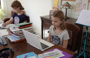 New York, USA. 2020. School children working from home during the Coronavirus lockdown,