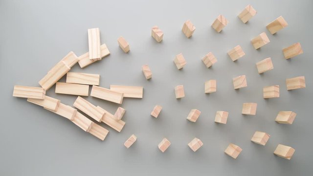Stop coronavirus. Keep safe social distance concept. Hand pushes dominoes, domino effect stops due to large distance. Preventive measures to combat global spread of the pandemic COVID-19. 4K footage.