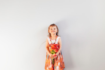 Little girl with bouquet of flowers.