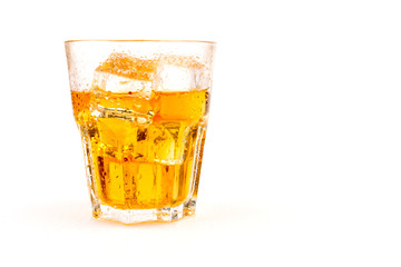 Glass of scotch whiskey and ice over white background.