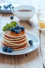 Homemade pancakes, fresh summer berries, coffee and juice